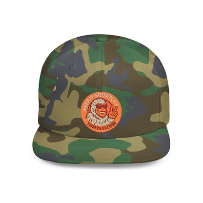 Camouflage flat brim hat with Tom Yeti logo patch and green undervisor snapback cap