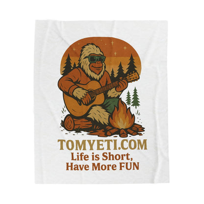 Tom Yeti Official plush blanket with yeti playing guitar by campfire design