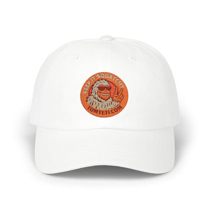 White dad cap with embroidered orange "Keep It Squatchy" logo and adjustable snapback closure